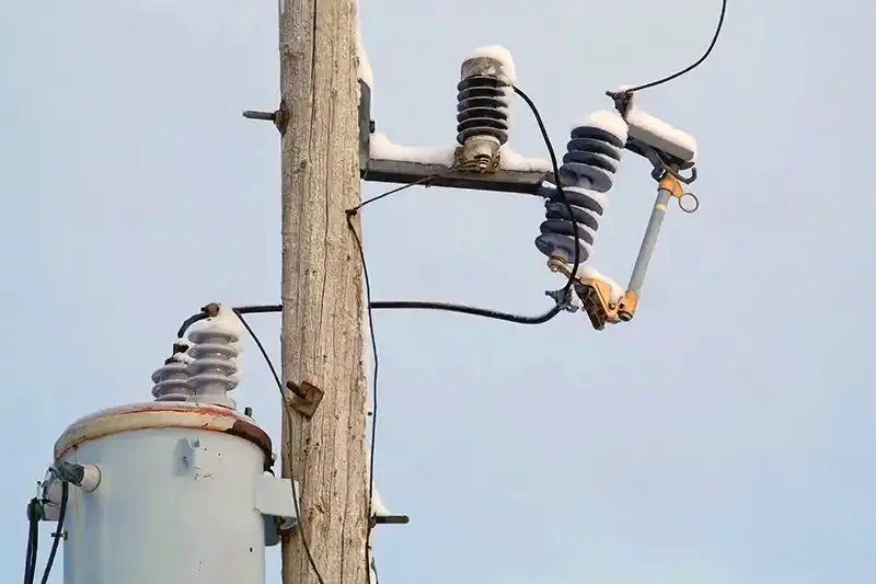 Telephone or utility power pole fuse surge protector and transformer during winter