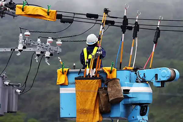 lineman installing cable clamps