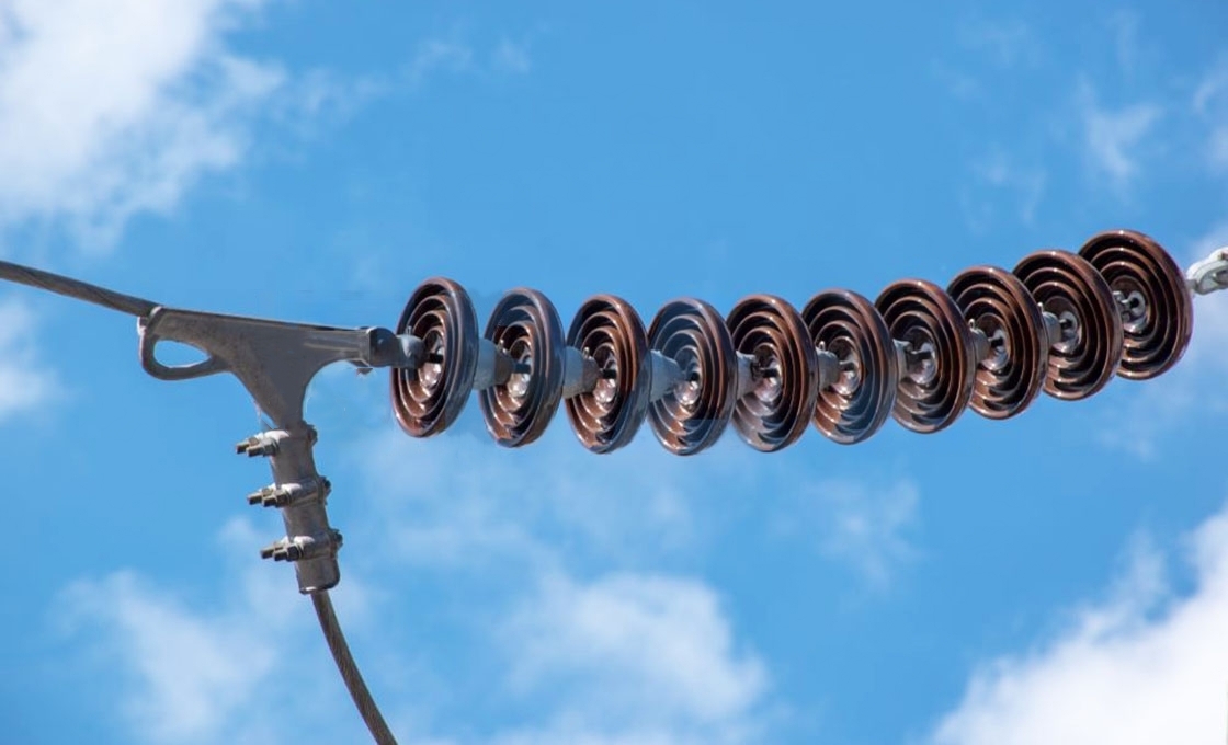 Suspension insulators are devices used to support transmission lines on steel towers and isolate the lines from the tower.